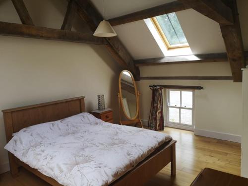 a bedroom with a large bed and a mirror at Lovely 3-Bed House at Clashganny Mill Borris in Carlow