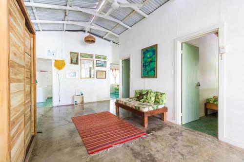 a living room with a couch and a rug at Bajo el Arbol B&B in Santa Teresa Beach