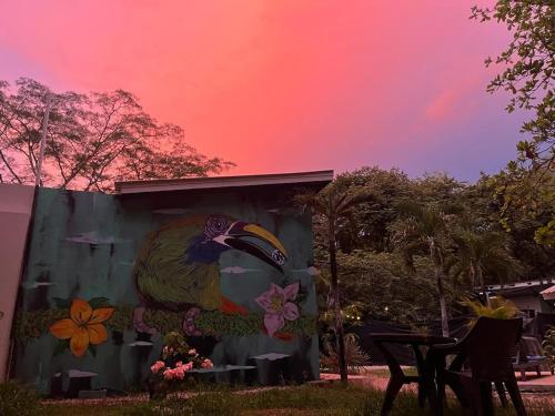 a painting of a parrot on the side of a building at Puerta Negra in Playa Flamingo