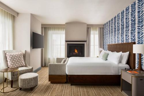 綠灣的住宿－Hotel Northland, Autograph Collection，酒店客房配有一张床和一个壁炉。