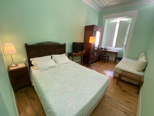 Ένα ή περισσότερα κρεβάτια σε δωμάτιο στο União - Guest House