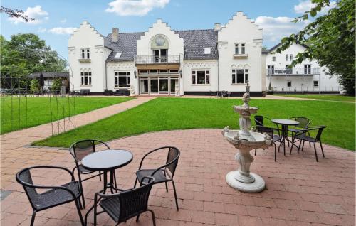 a group of tables and chairs in front of a building at 11 Bedroom Cozy Home In Gørding in Gørding