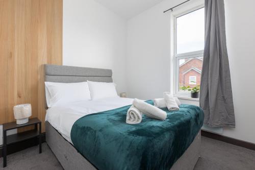 a bedroom with a large bed with a window at Prism Everyday - One Bed Apartment in Blackpool
