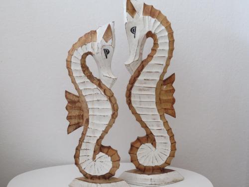a wooden sculpture of two seahorses on a table at Cotillo Star by NicoleT in Cotillo