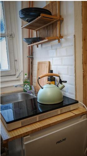 une bouilloire assise sur une cuisinière dans l'établissement Studio Montmartre!, à Paris
