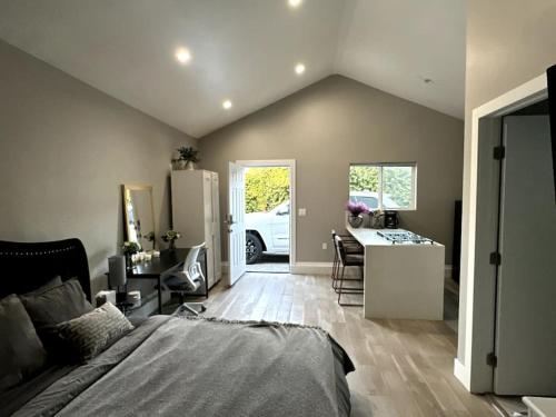 a bedroom with a bed and a kitchen with a refrigerator at Cozy Private Guest House Pet Friendly Free Parking in Los Angeles