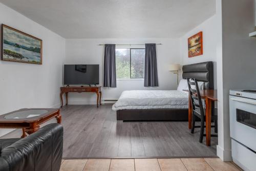 a hotel room with a bed and a tv at Croft Inn Motel in Crofton