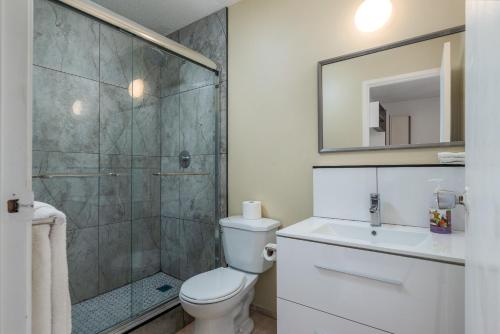 a bathroom with a shower and a toilet and a sink at Croft Inn Motel in Crofton