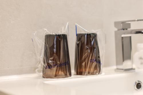 two brown vases are sitting on a counter at Villa 1927 in Belgrade