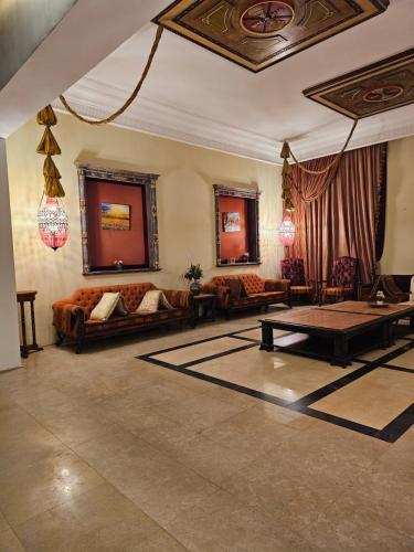 a living room with couches and a table at مزرعة الاسترخاء in Umm Al Quwain