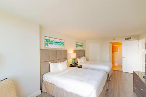a hotel room with two beds and a television at Intracoastal Waterview - Central- Fort Lauderdale - Steps to Beach in Fort Lauderdale