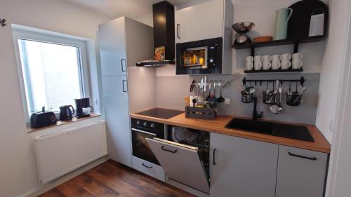 Una cocina con estufa, fregadero y ventana. en alte Bäckerei Bautzen - 05 #Gallery# im Zentrum, mit Parkplatz, Top Ausgestattet, für Gruppen geeignet, en Bautzen