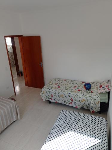 a living room with a bed and a rug at Casa de praia Melo in Itanhaém