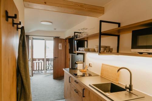 a kitchen with a sink and a counter at Weßner Hof Landhotel & Restaurant in Marquartstein