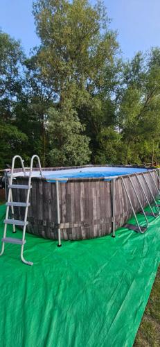 a trampoline on a green blanket next to a pool at Na Kamieńcu in Czarny Dunajec