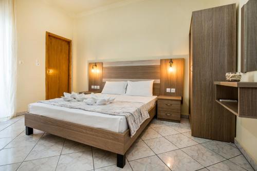 a bedroom with a large bed in a room at Ianos Apartments in Potos