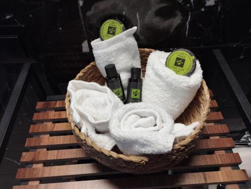 a basket of towels and cosmetics on a table at Arcade City Apartment in Rethymno