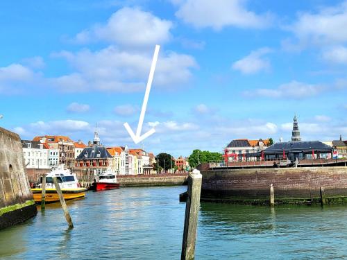 a view of a river with buildings and boats at Appartement Havenzicht, gelegen aan zee met zeezicht in Vlissingen