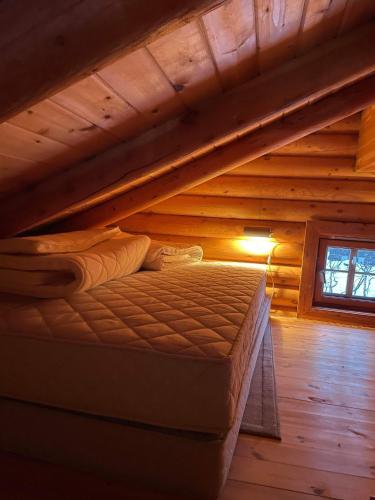 a bed in the attic of a log cabin at Hovden in Hovden