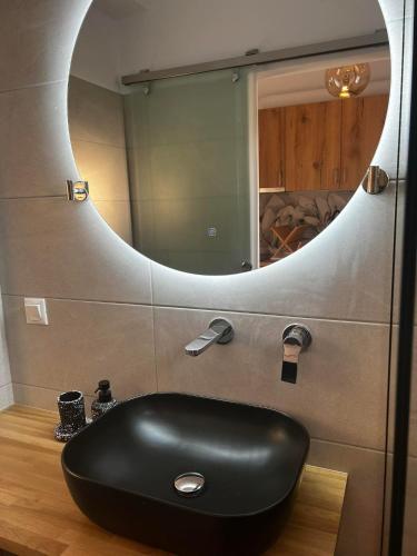 a black sink in a bathroom with a mirror at Eleni B&B in Limánion