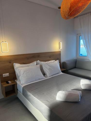 a bedroom with a large bed and a couch at Eleni B&B in Limánion