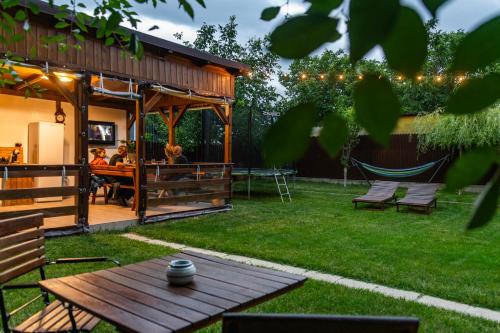 a backyard with a picnic table and a gazebo at Casa lui Matei Murighiol in Murighiol