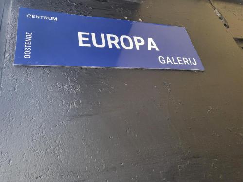 a blue sign on a wall with the word europezona at SeaCityView Oostende in Ostend