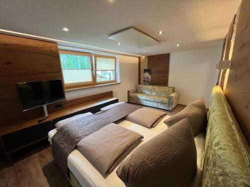 a bedroom with a bed and a flat screen tv at Ferienwohnung Tux in Tux