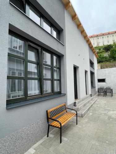 a bench sitting next to a building with windows at Comfortable apartments under the St. Barbara´s Cathedral in Kutná Hora