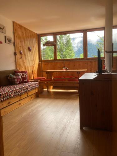 a living room with a couch and a large window at Residence Larici Belvedere in Folgarida
