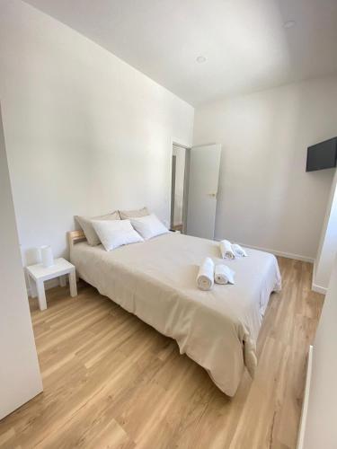 a bedroom with a large bed with two towels on it at Casa da Nespereira in Portimão