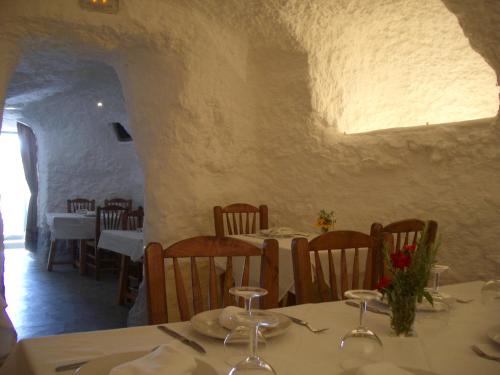 a dining room with tables and chairs in a building at Al Jatib in Baza
