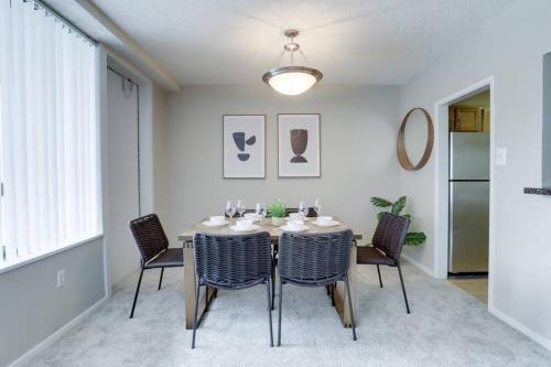 a dining room with a table and chairs at Wonderful 2BR Condo @Crystal City With Gym in Arlington