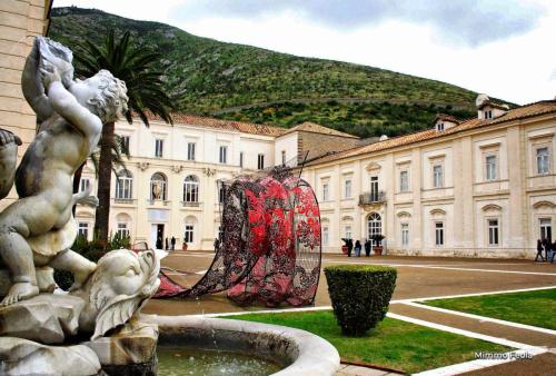 a statue in front of a building with a fountain at B&B Royal Palace of Napoli & Reggia di Caserta in Caserta