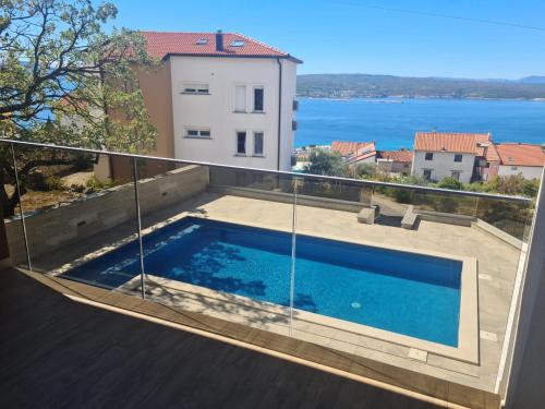 a swimming pool on the balcony of a house at Apartment Ankica in Crikvenica