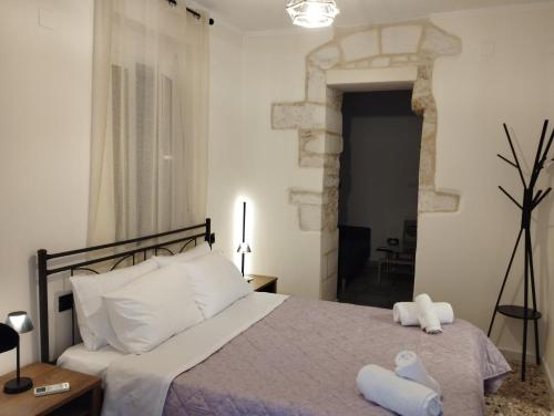 a bedroom with a bed with two towels on it at Arcade City Apartment in Rethymno