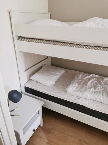 a bedroom with two bunk beds and a desk at Bøvervegen 19 Appartment nr 9 in Bjorli