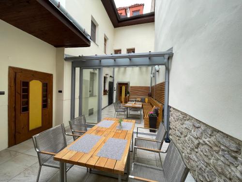 a patio with a wooden table and chairs at Ubytovanie u Janusa in Levoča