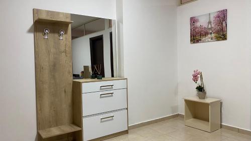 a bathroom with a sink and a mirror at Ona’s Apartments in Lushnjë