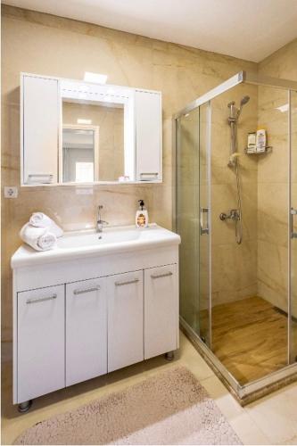 a bathroom with a white sink and a shower at BODRUM BURCU VILLA , Magnificent Sea View, Cozy, Free Otopark, Free Wifi in Bodrum City