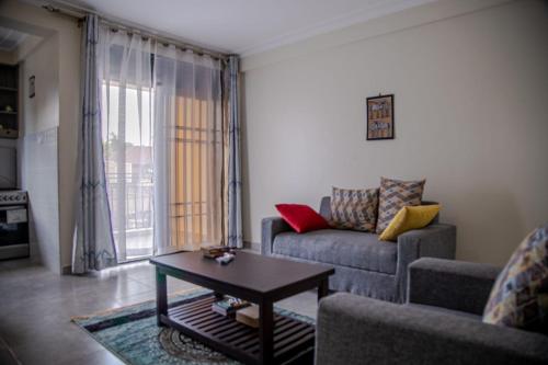a living room with a couch and a table at Eric and Devota apartments Kampala in Buwate