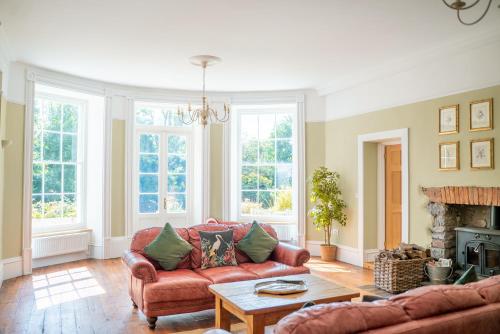 a living room with a couch and a table at Holyland House - Greenacres Estates in Pembrokeshire