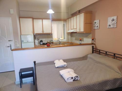 a bedroom with a bed with towels on it at Mixaleas apartments in Kalamata