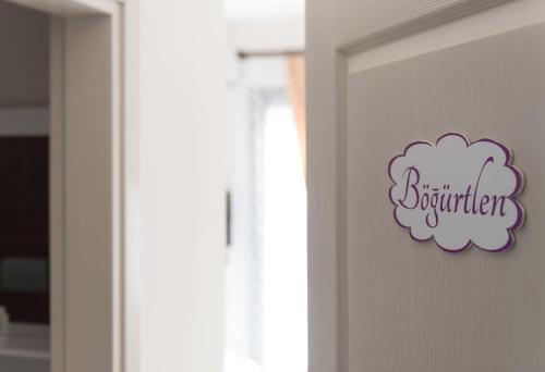 a door with a cloud sign on it at Cilek Butik Hotel in Cesme