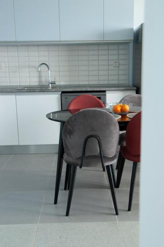 a kitchen with a table with chairs and a sink at Seaview apartments in Ayios Elias