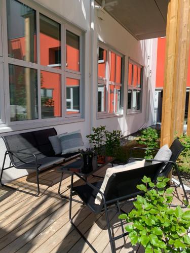 a patio with a couch and a table and chairs at Apartment in Breiviken in Bergen