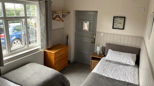 a bedroom with a bed and a window at Nanny Goat Rest At Ashlands Farm in Abbots Bromley