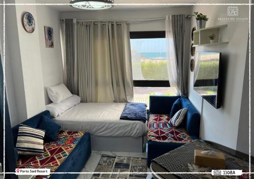 a small room with two beds and a couch at Porto said Resort - Luxury Studio Seaview 43 m2 شالية إستوديو فندقي فاخر فيو البحر in `Ezbet Shalabi el-Rûdi