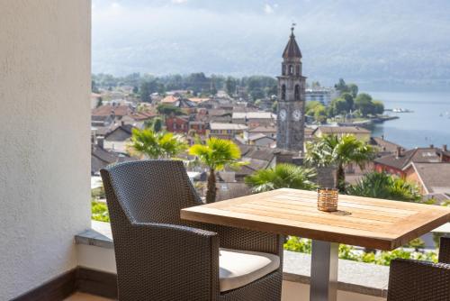 a table and chairs with a view of a city at VIEW Appartement including Parking in Ascona