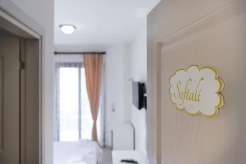 a room with a sign on the door of a bedroom at Cilek Butik Hotel in Çeşme